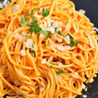 spaghetti tossed in Pomodoro sauce on a plate with Parmesan