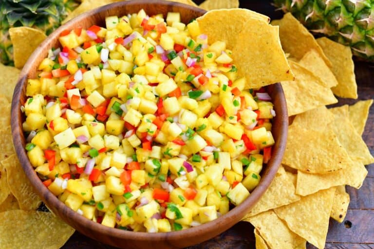 Chips are served alongside pineapple salsa.