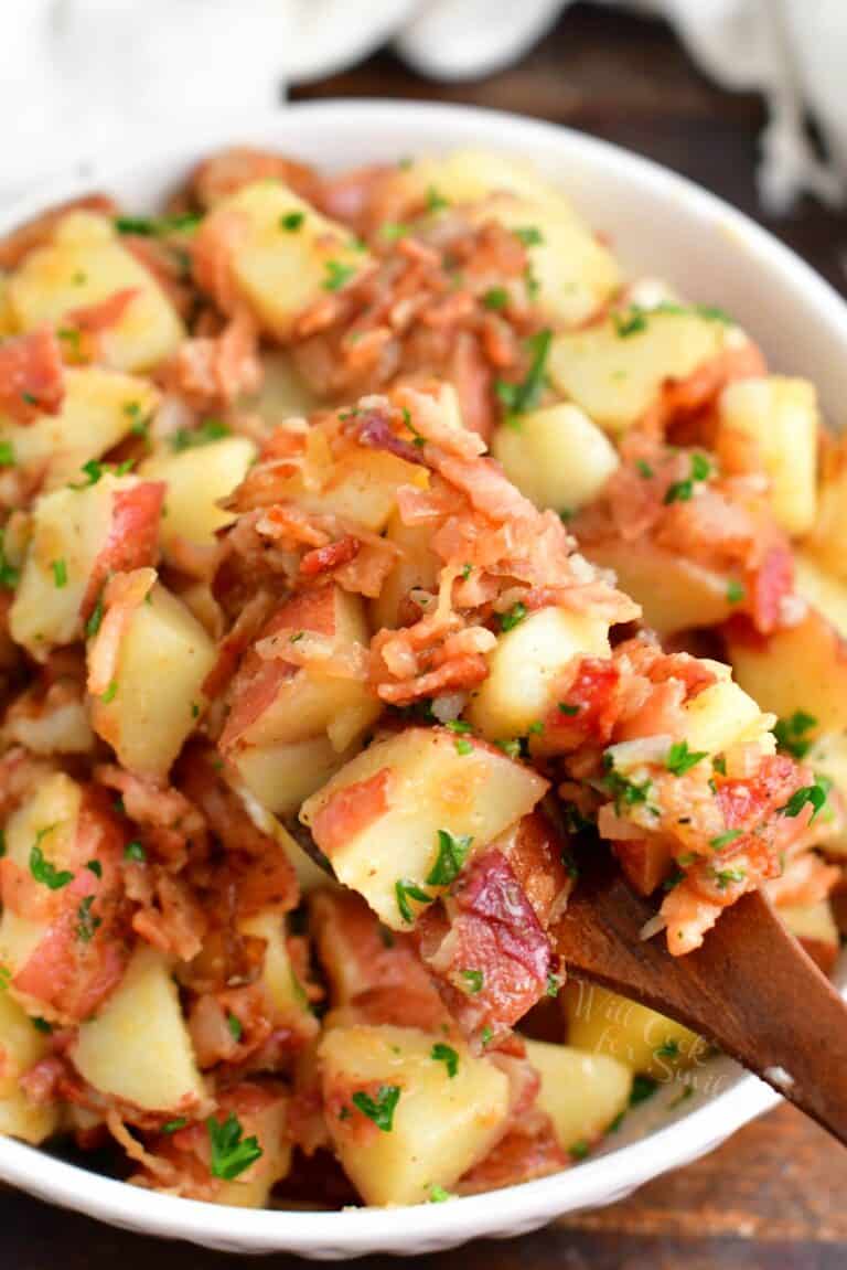 Bacon, parsley, and dressing are tossed with potatoes.