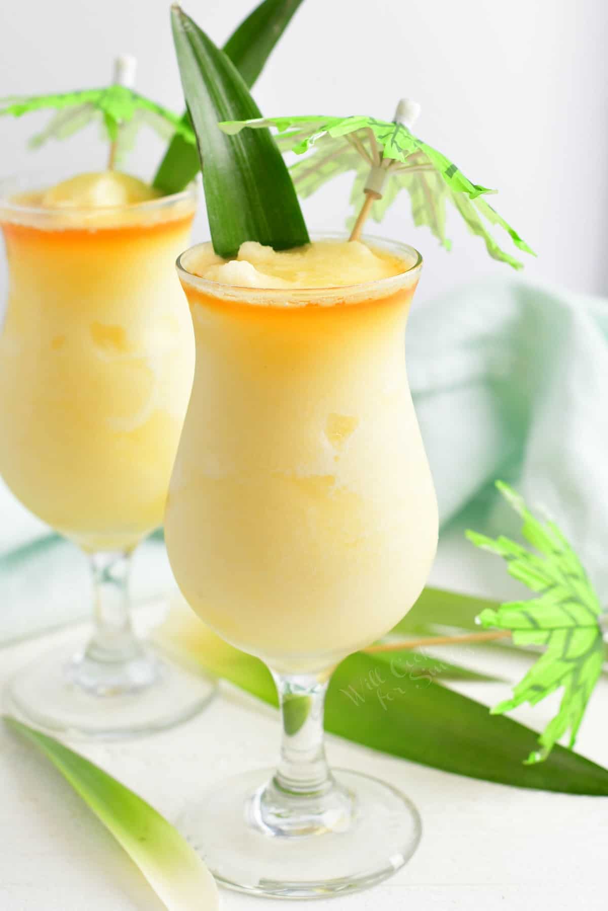 A pina colada is placed on a white surface. 