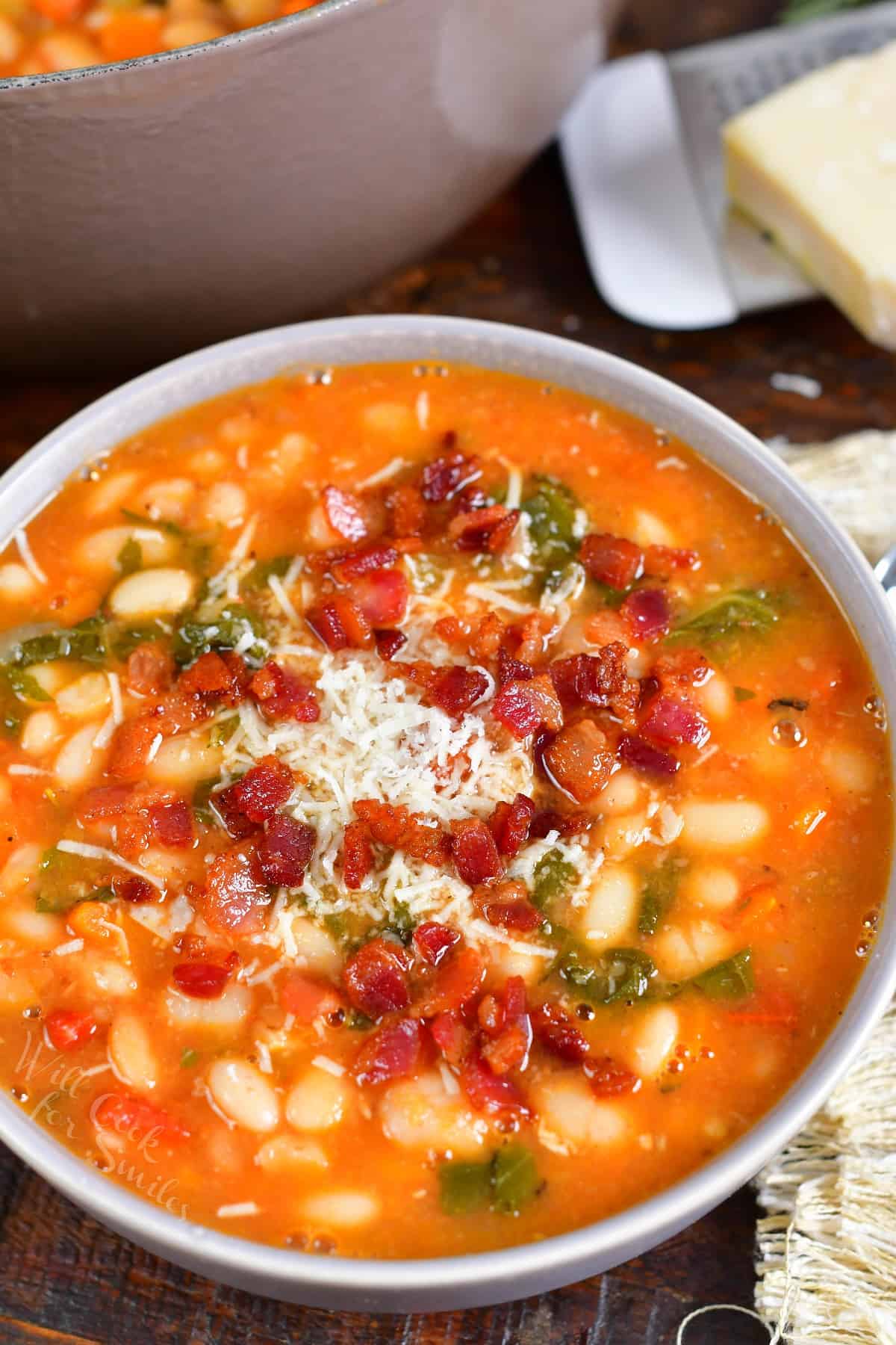 A bowl of soup is garnished and ready to eat.