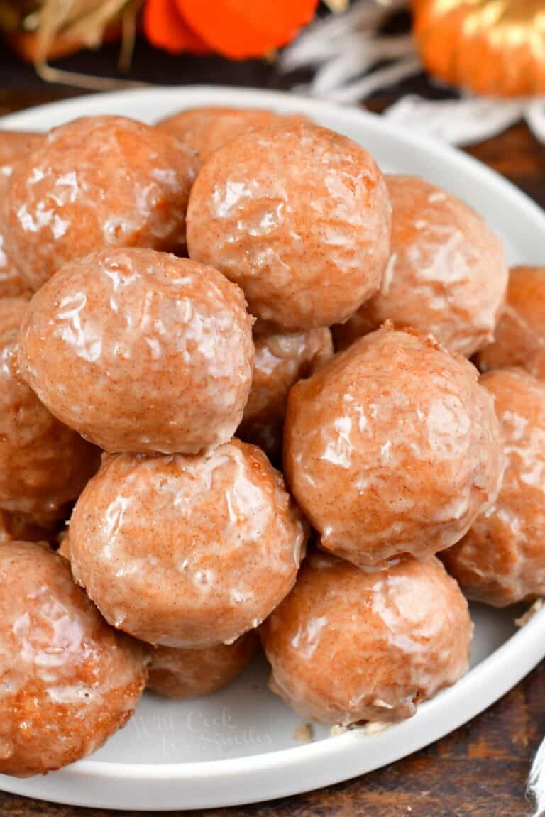 top view of the iced pumpkin doughnuts on a plate