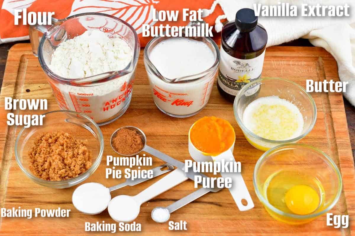 labeled ingredients to make pumpkin donut holes on wooden cutting board.