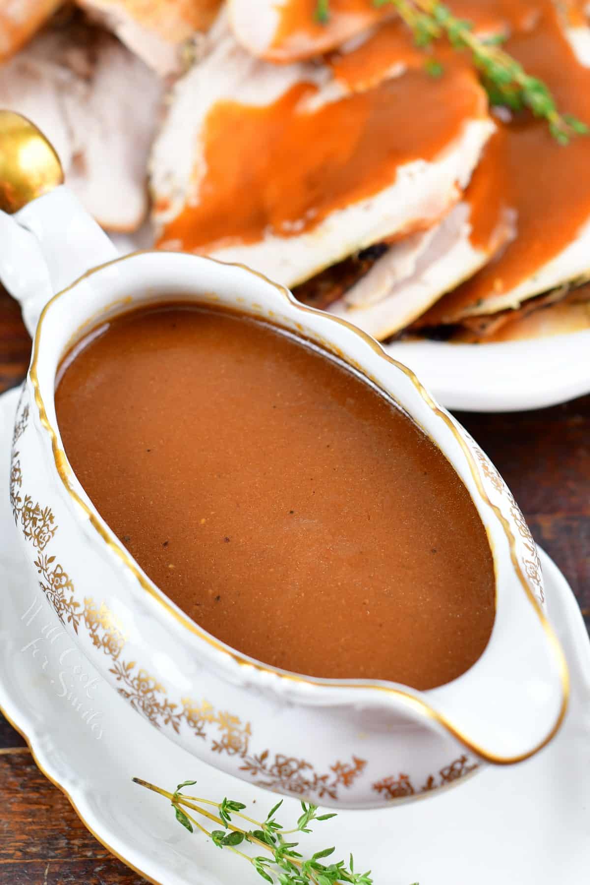 turkey gravy in a white and gold gravy boat