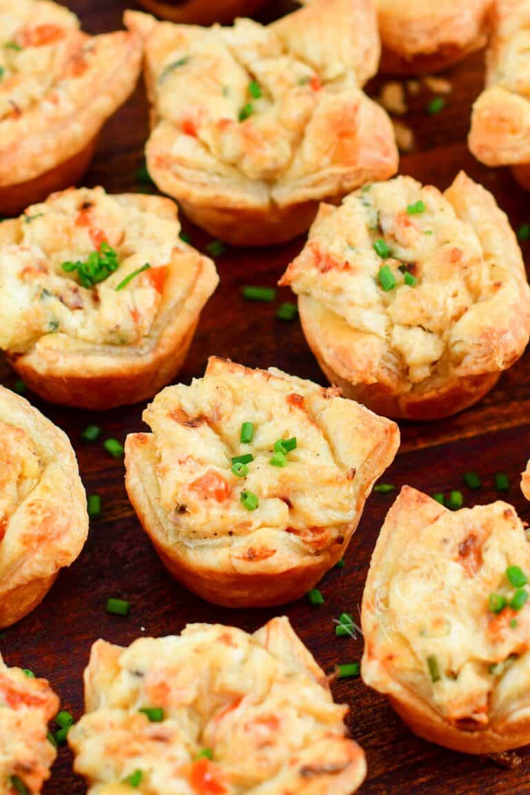 closeup of a few crab puffs on a wooden plate