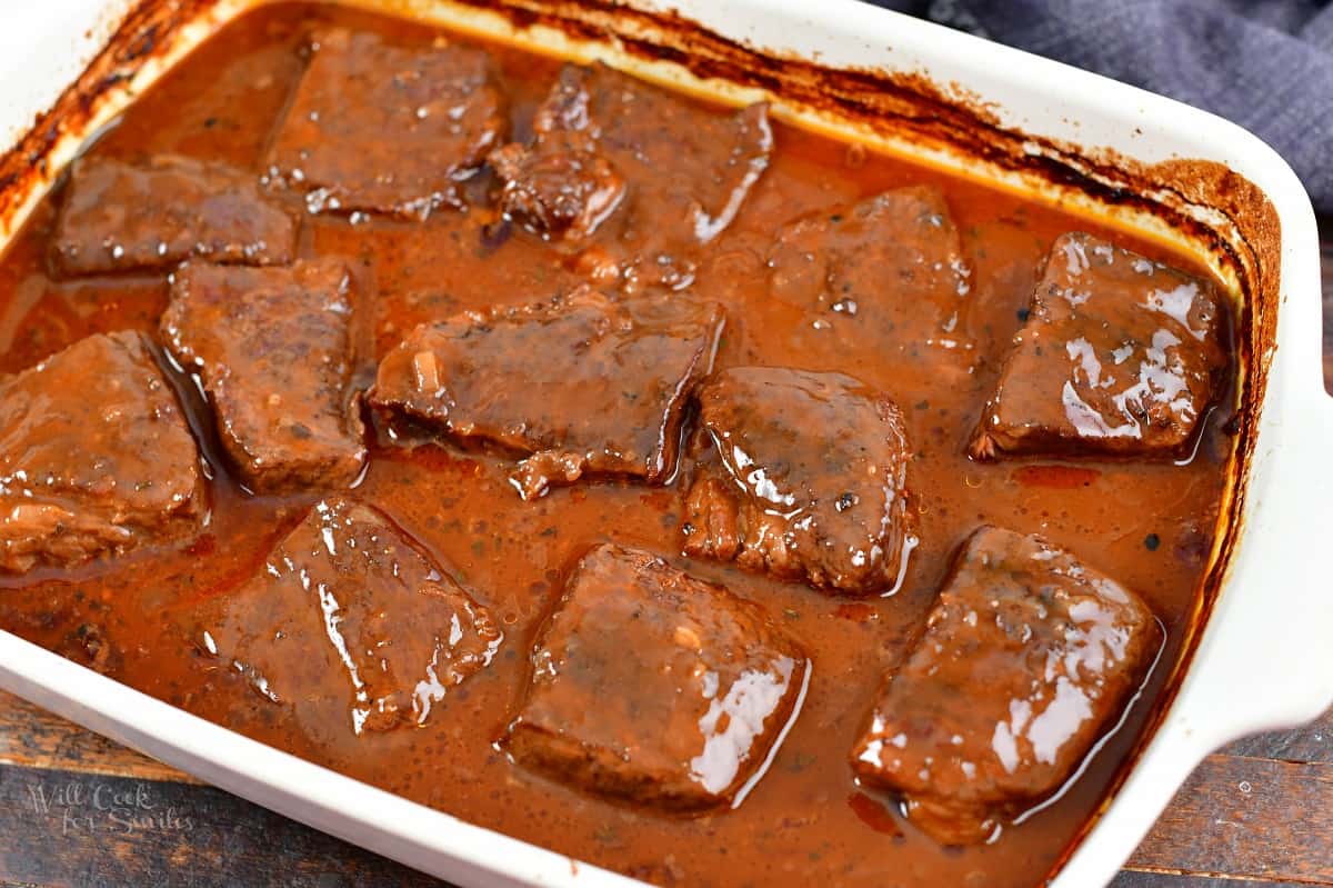 baked boneless short ribs in sauce in a baking dish.