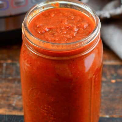 pasta sauce in a glass jar next to Instant Pot