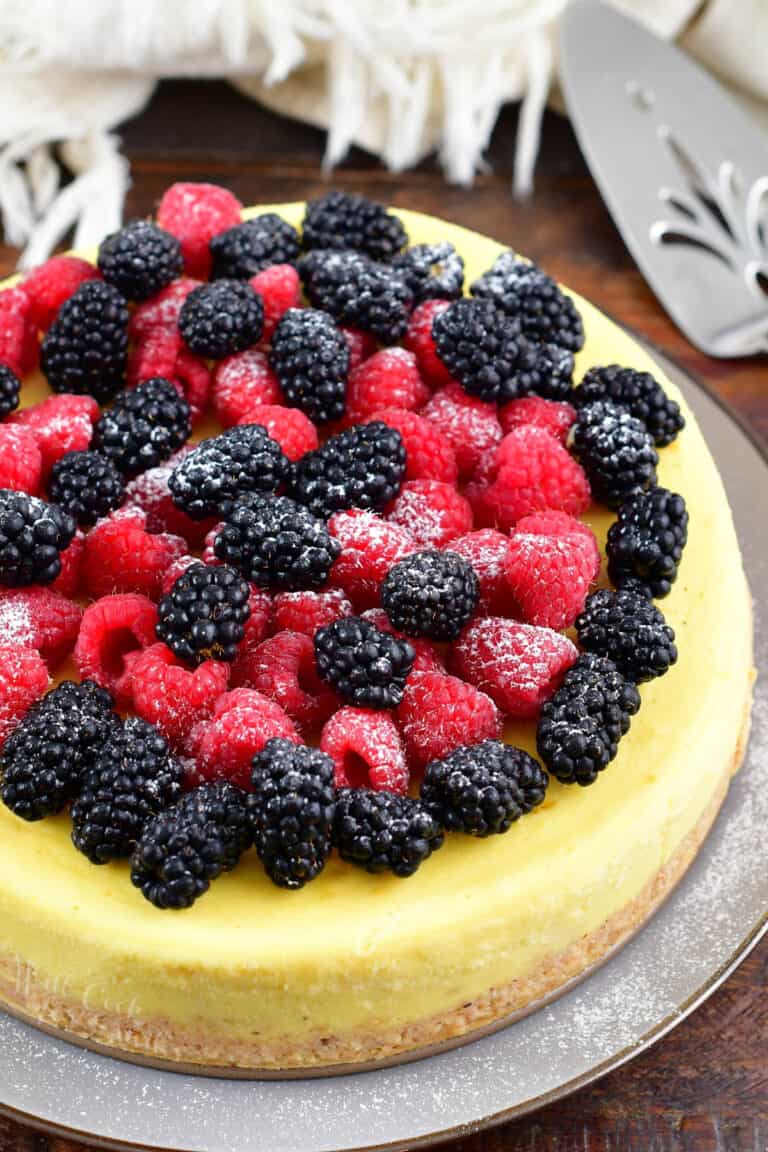 top view of a whole ricotta cheesecake topped with berries