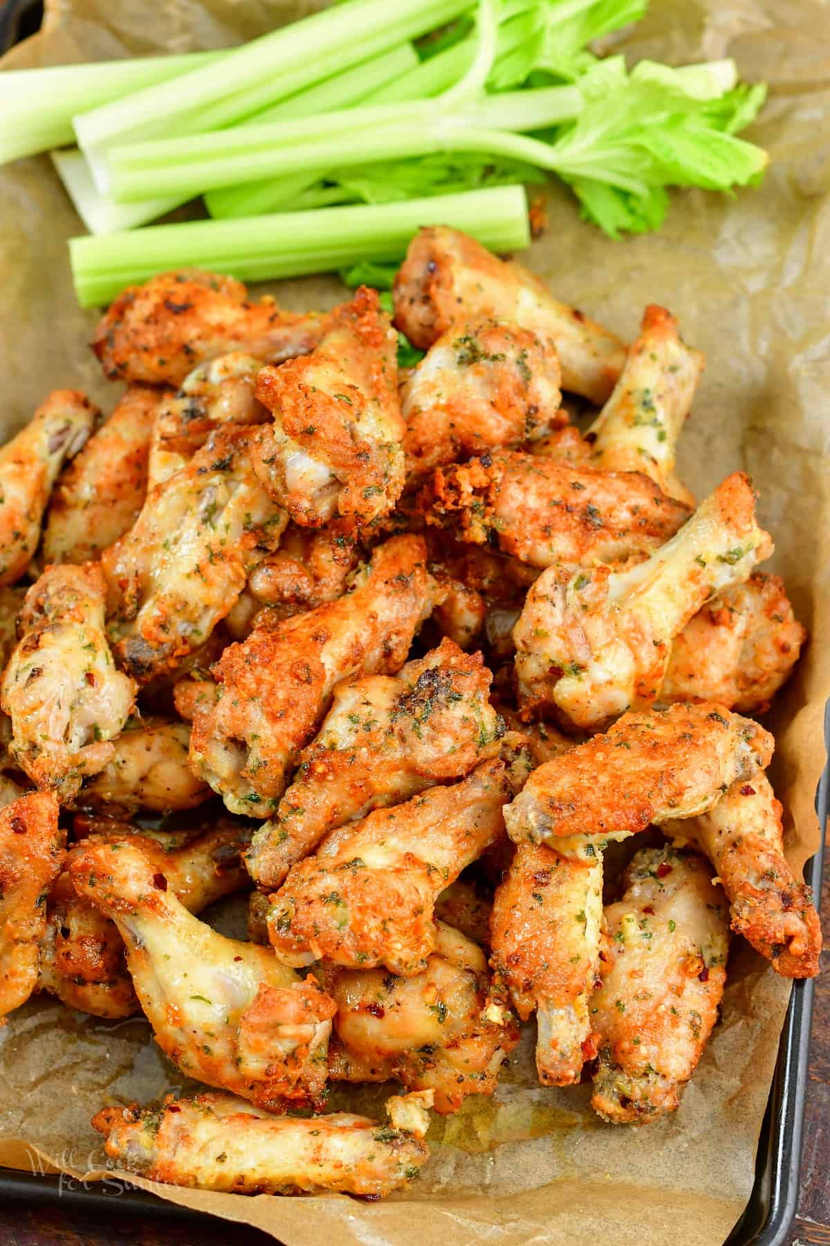 top view of crispy air fryer chicken wings and celery sticks