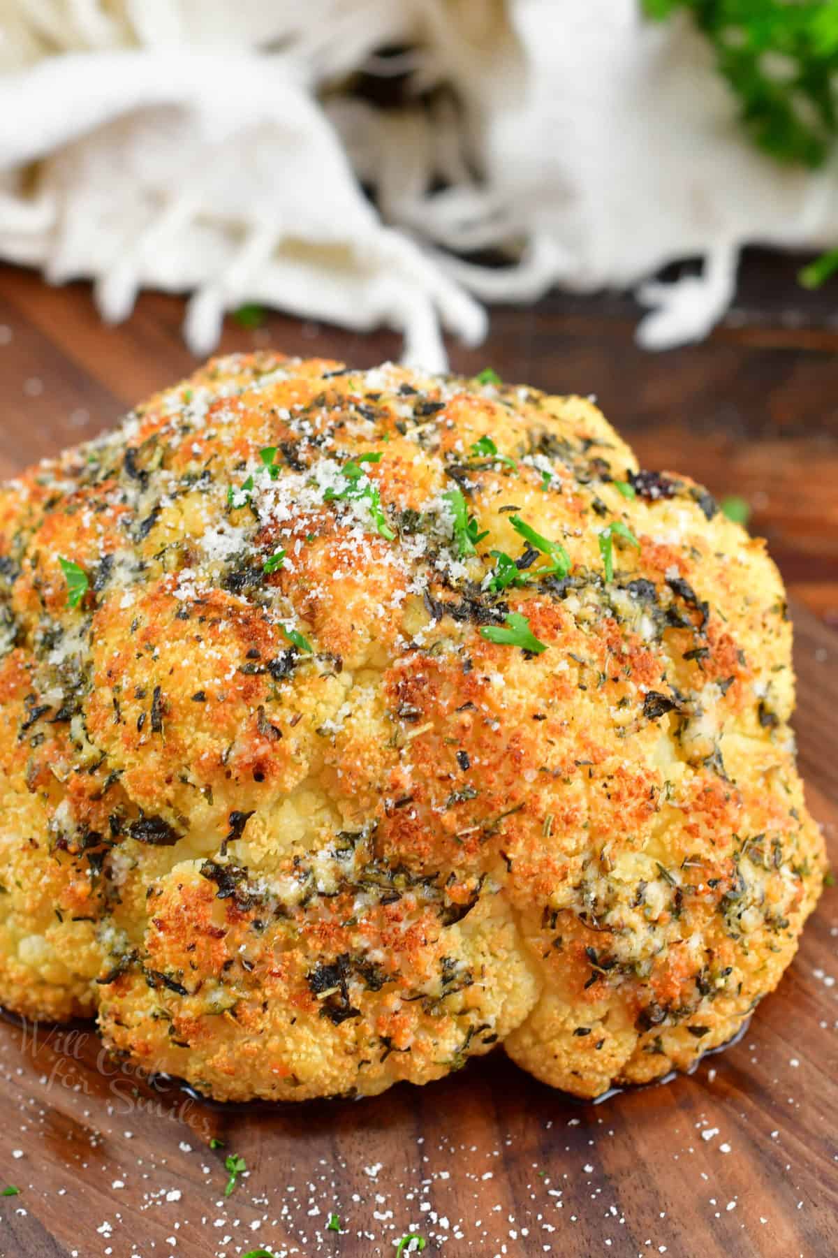 closeup of roasted whole cauliflower on a board