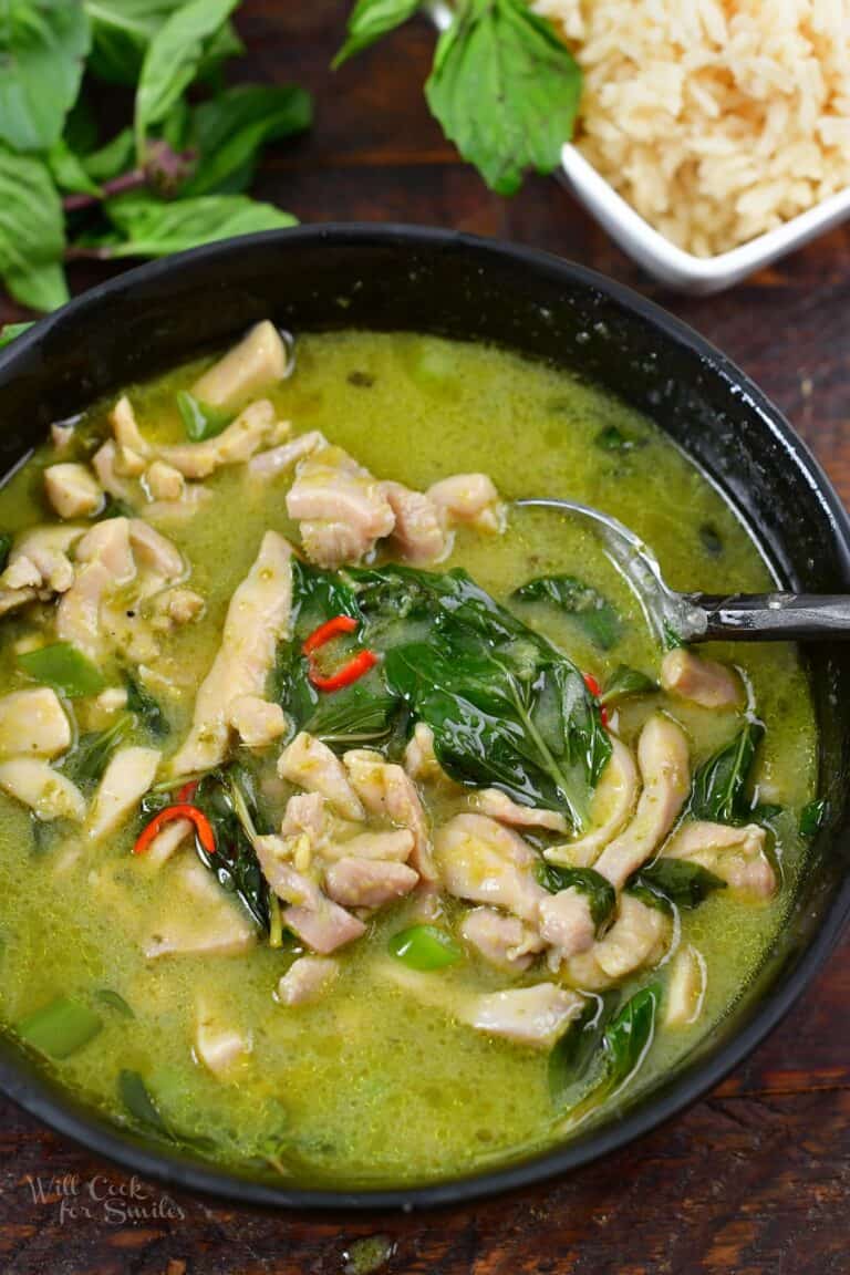 spooning some green curry out of the bowl