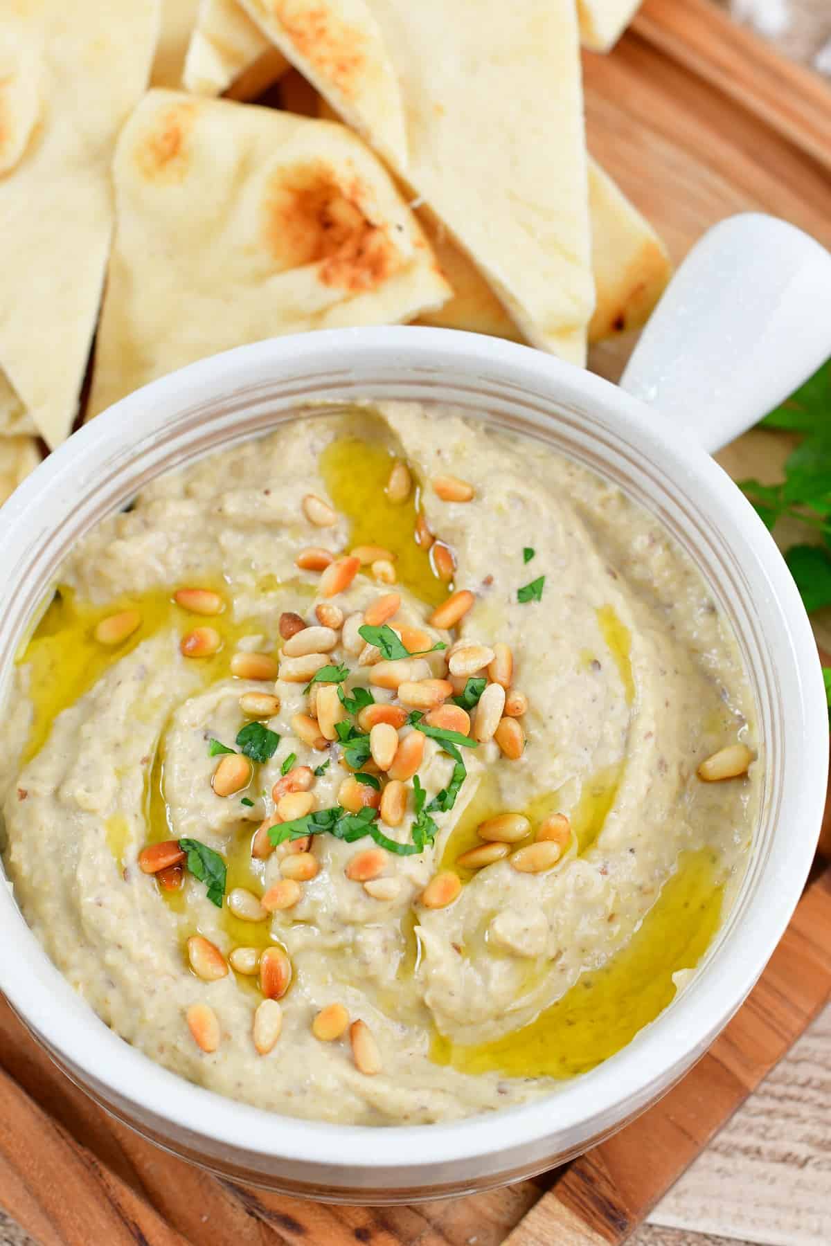 top view of the baba ganoush in a bowl with pine nuts