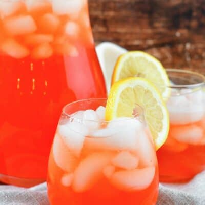 front view of pink lemonade in glasses and jar