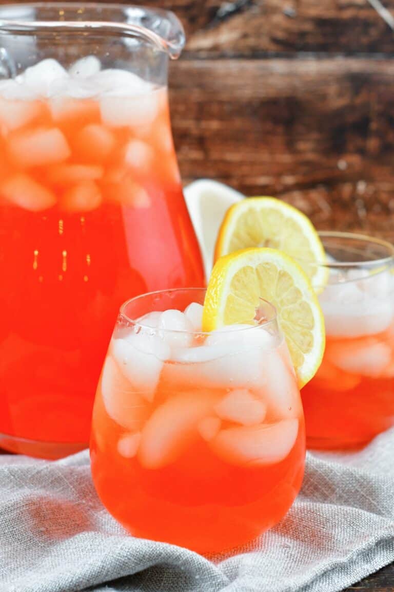 front view of pink lemonade in glasses and jar