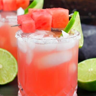 closeup watermelon margarita in a glass with salt