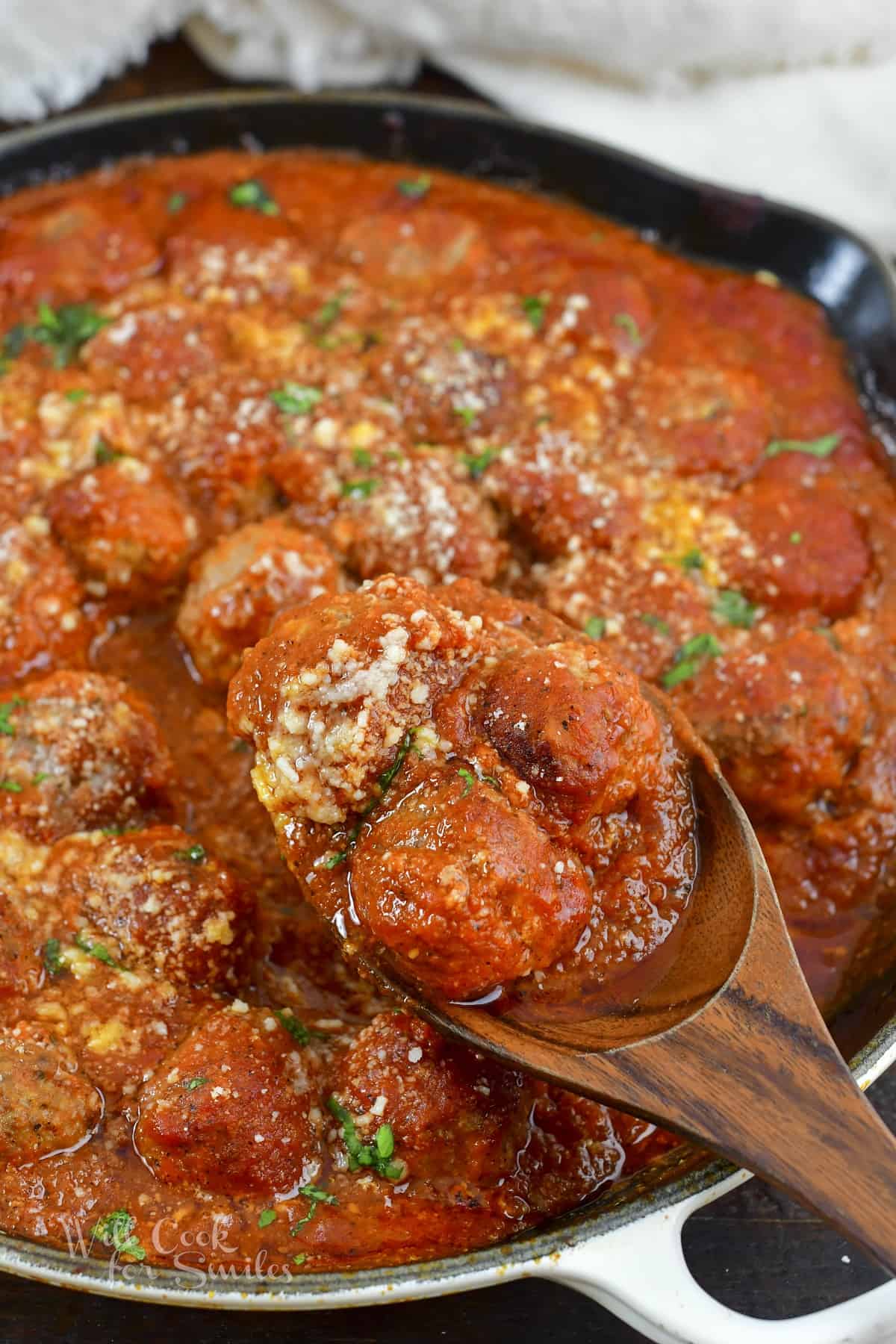 scooping out some Italian meatballs in sauce