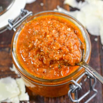 squared scooping tomato pesto with a spoon