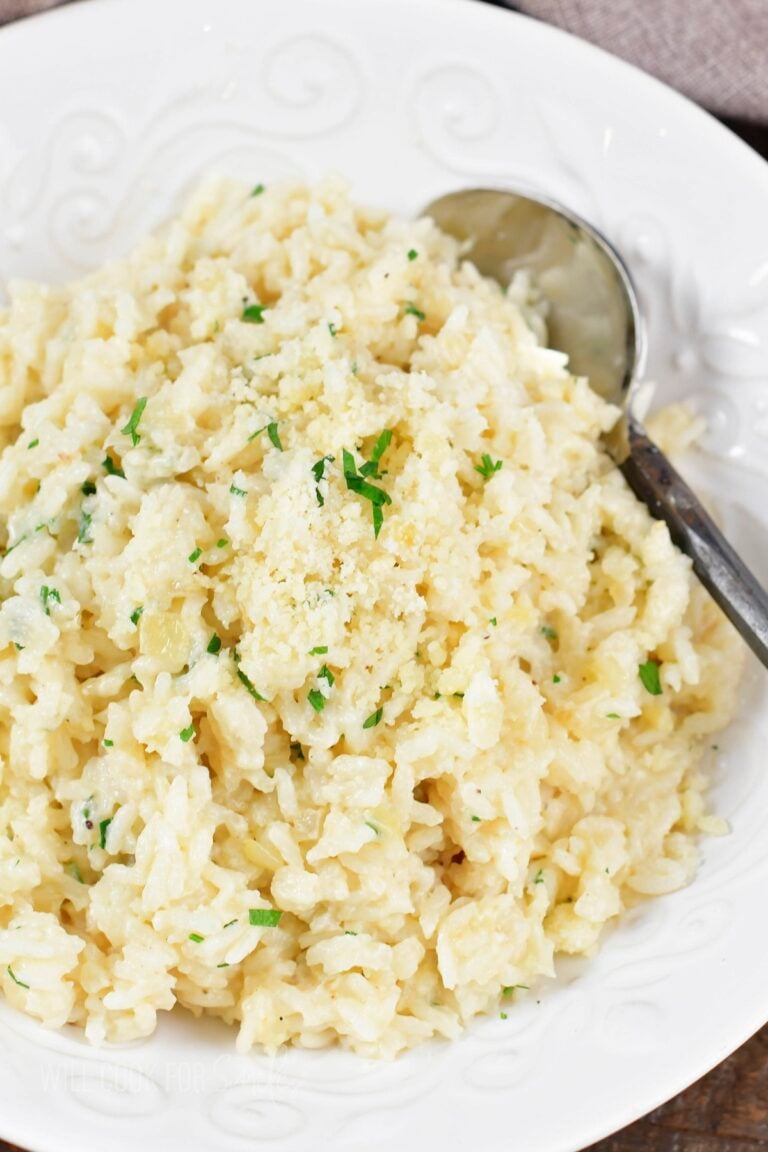 closeup top of parmesan rice in a white bowl.