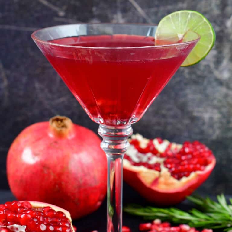 centered image of a bright red cocktail in a martini glass.