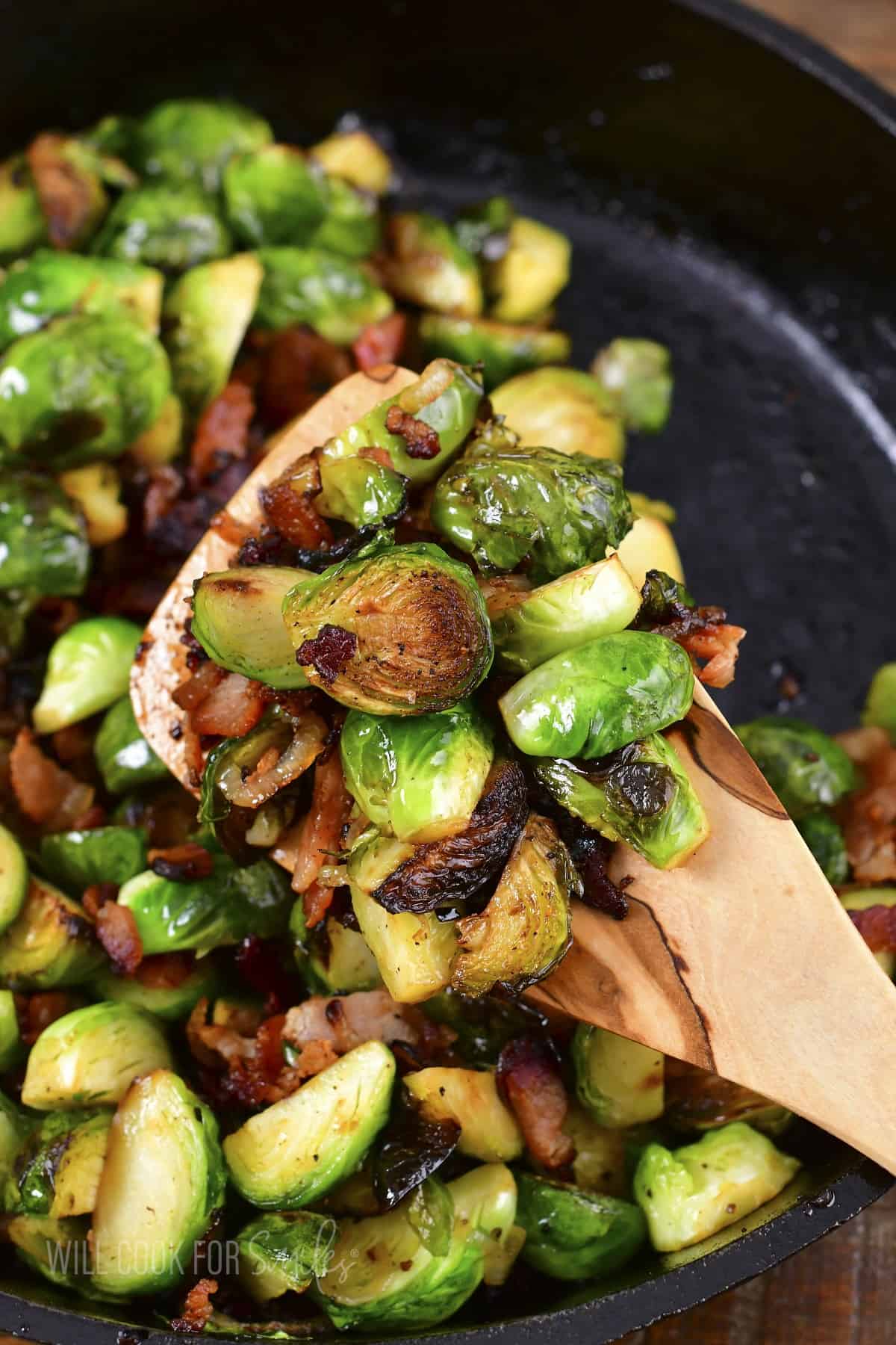 scooping out some roasted brussels from the pan.