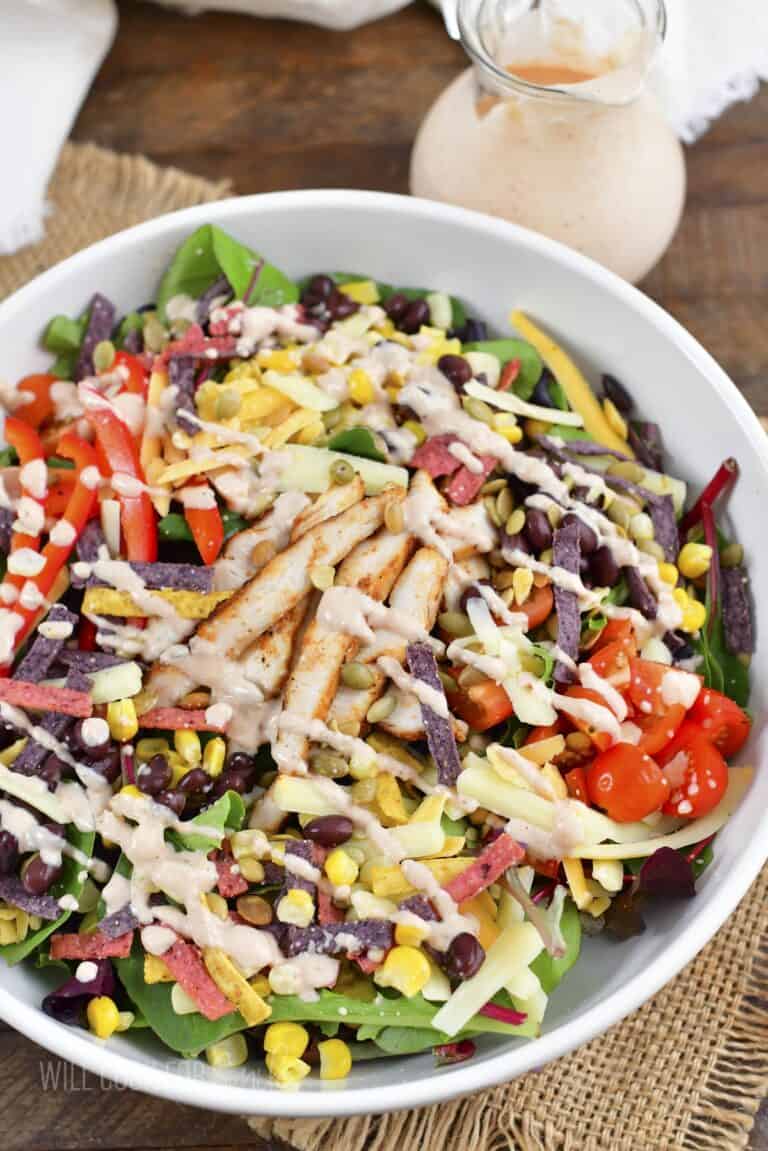 top view of southwest salad in a bowl drizzled with dressing.