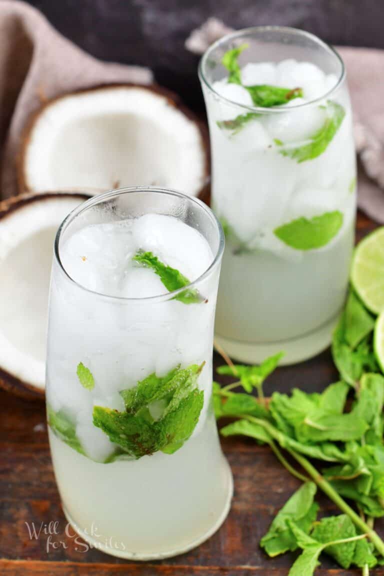 closeup of two slice and green coconut mojito cocktails.