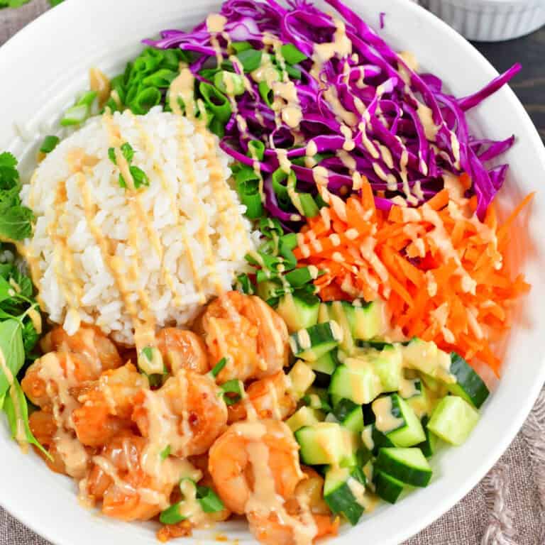 closeup of the top view of spring roll bowl drizzled with peanut dressing.