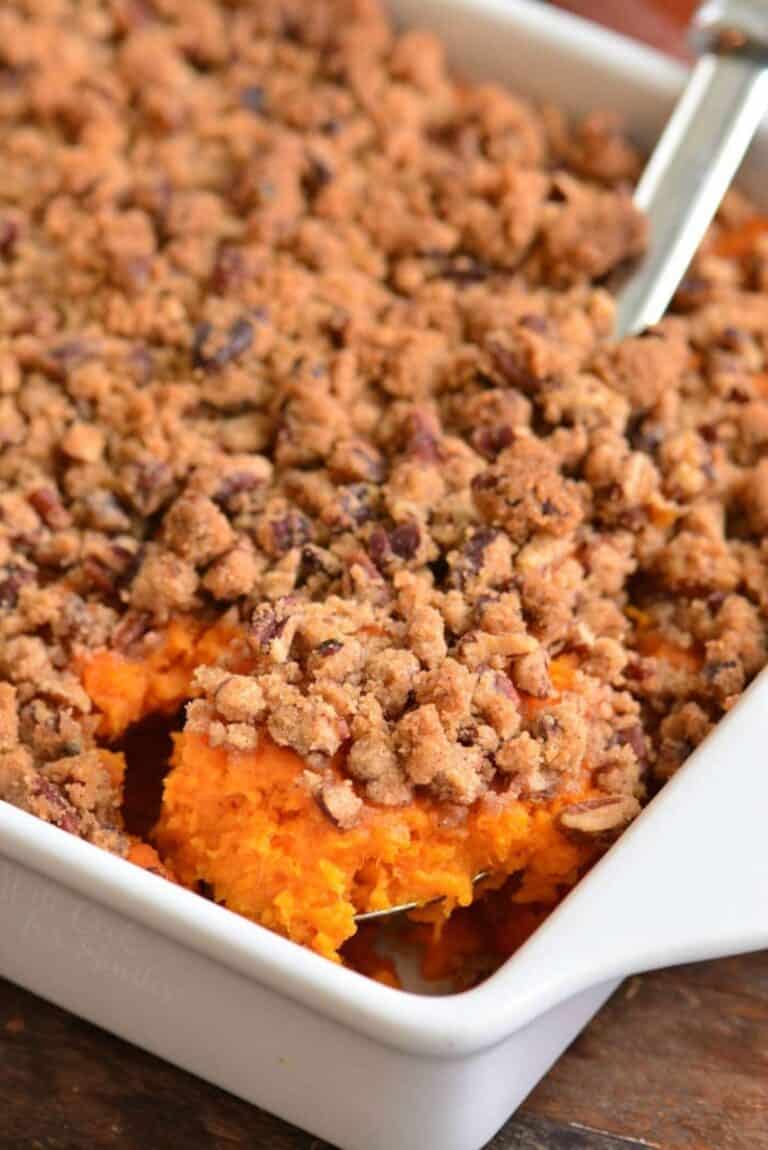 scooping out some sweet potato casserole with sweet pecan crumble on top.