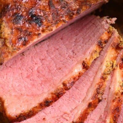 Corned beef sliced on a cutting board.