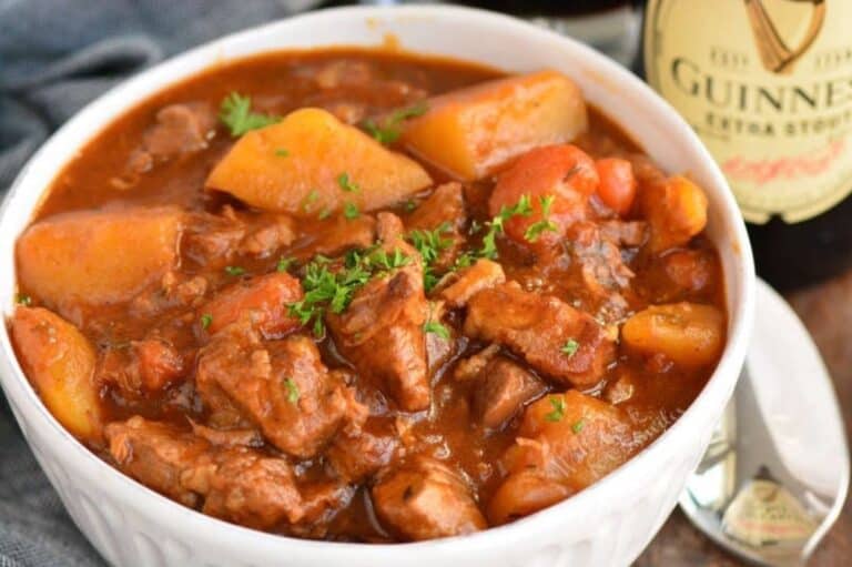 Irish beef stew in a bowl with parsley on top as garnish.