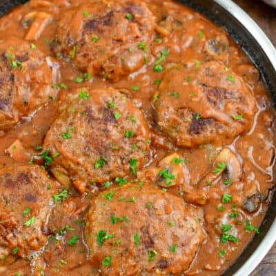 Salisbury Steak in a pan with parsley on top as garnish.