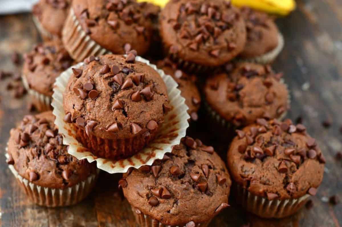 chocolate banana muffins with mini chocolate chips on top stacked.