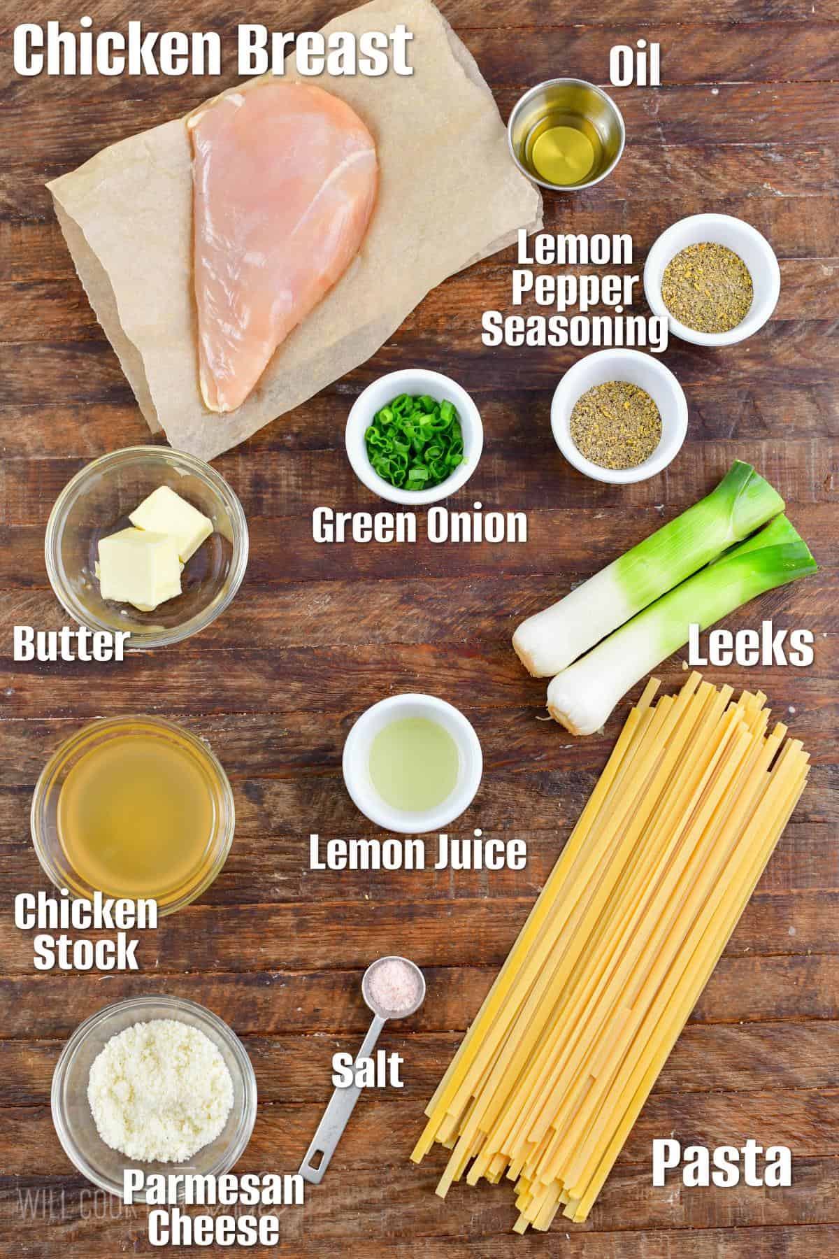 Labeled ingredients for lemon pepper chicken pasta on a wood cutting board.