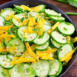Asian cucumber salad mixed with dressing in a serving bowl.
