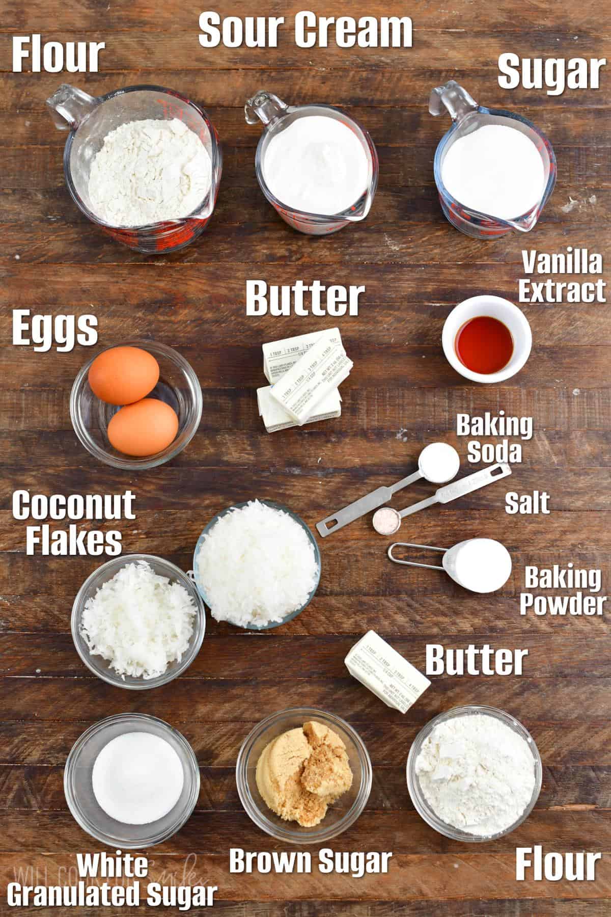Labeled ingredients for coconut coffee cake on a wood surface.