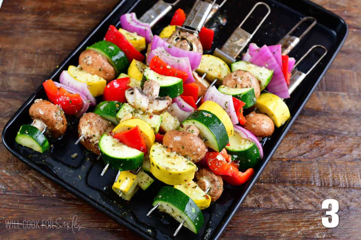 Italian Grilled Vegetables on skewers on a baking sheet before grilling