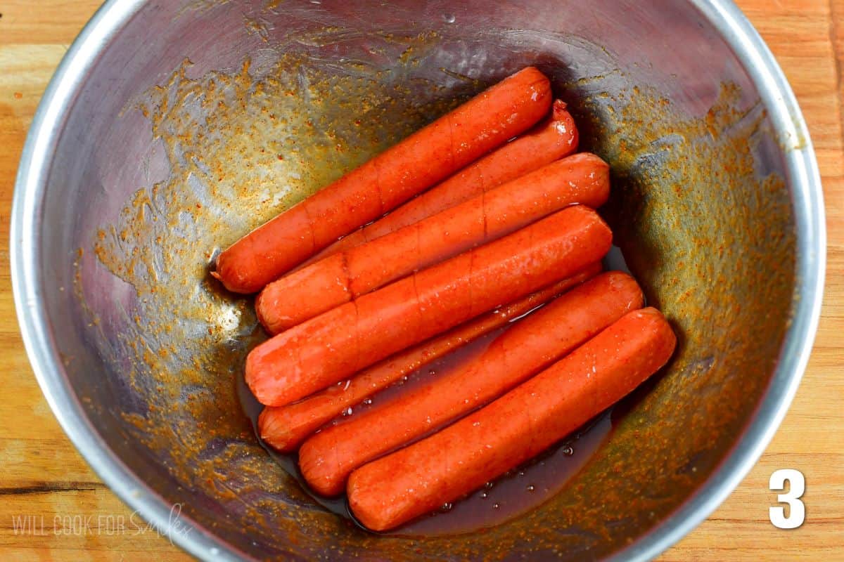 hotdogs in a bowl to marinade in the Siracha honey sauce.