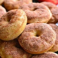 A stack of apple pie donuts on a wire rack.