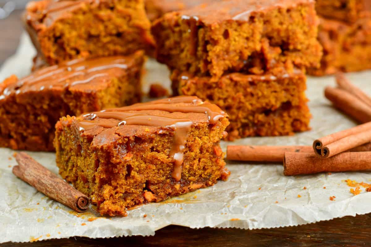 caramel pumpkin blondes cut into squares on parchment paper.