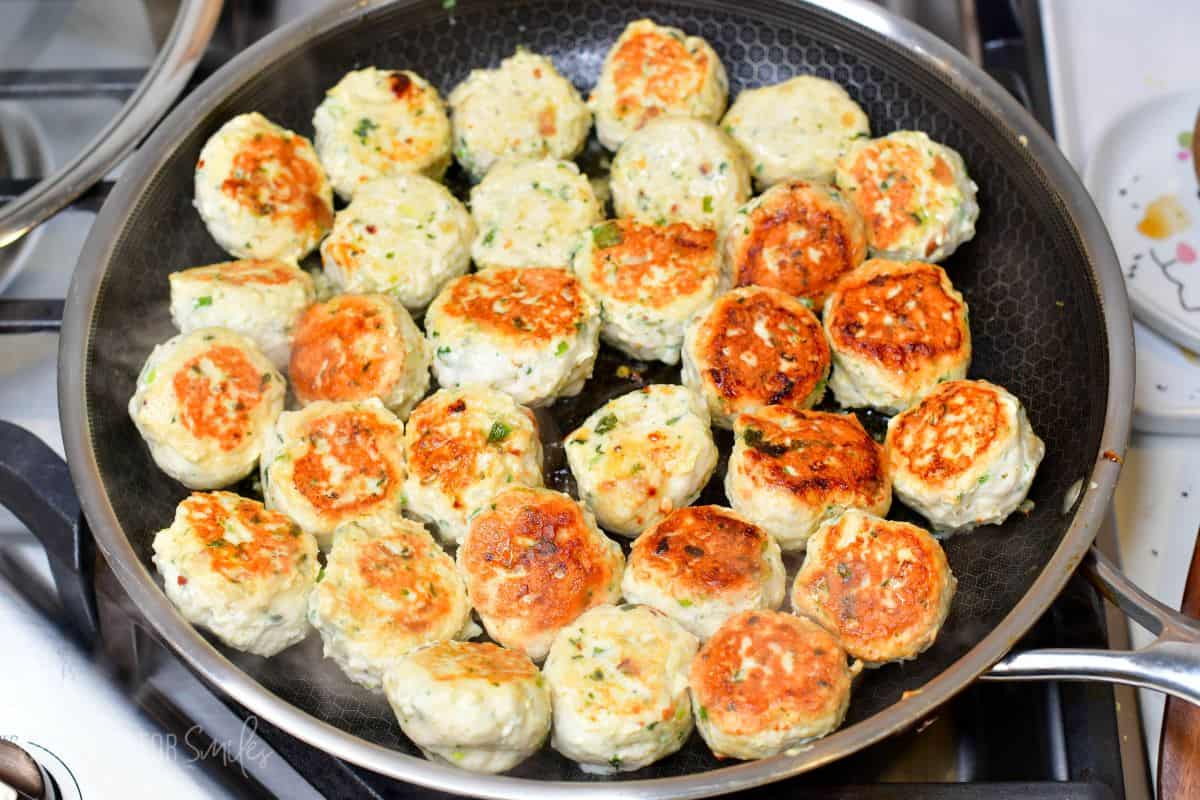 Thai Sweet Chili Turkey Meatballs cooking in a pan on the stove top.