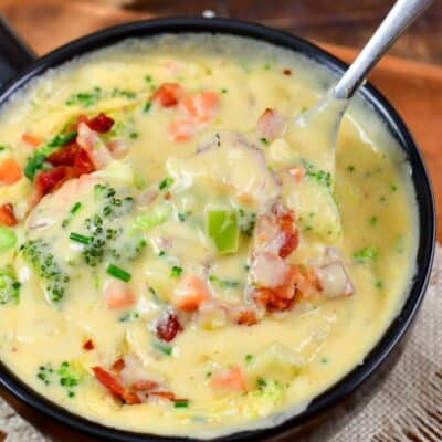 Bacon Broccoli Cheese Soup being scooped up with a spoon.