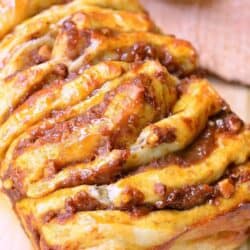 closeup of baked pumpkin pull apart bread on the cutting board.