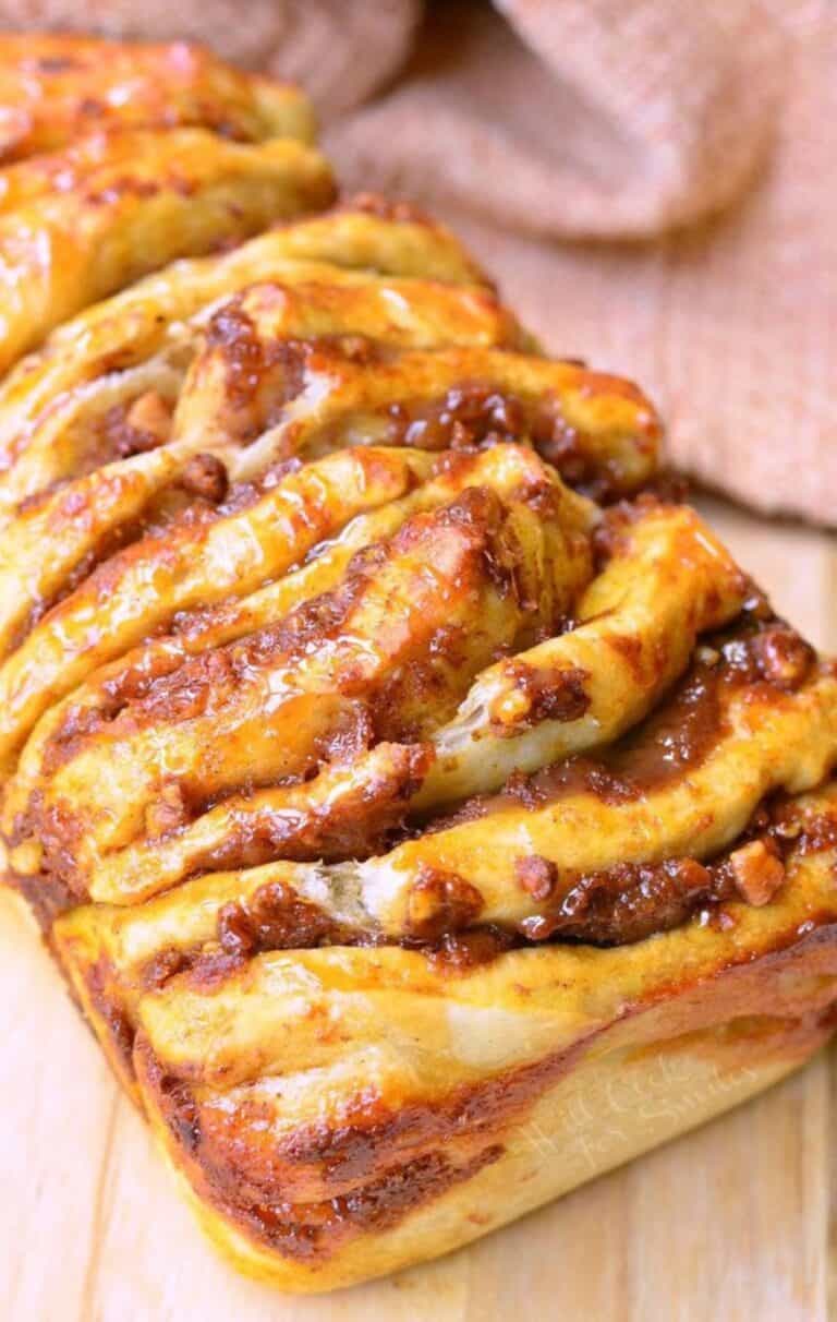 closeup of baked pumpkin pull apart bread on the cutting board.