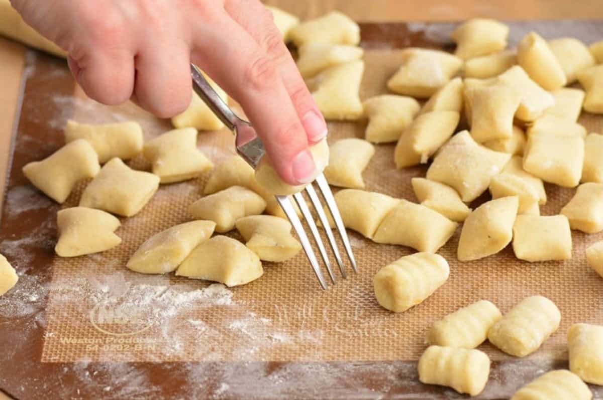 rolling the pieces of gnocchi on the fork.