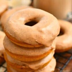 stack of four pumpkin spice baked donuts with glaze on top.