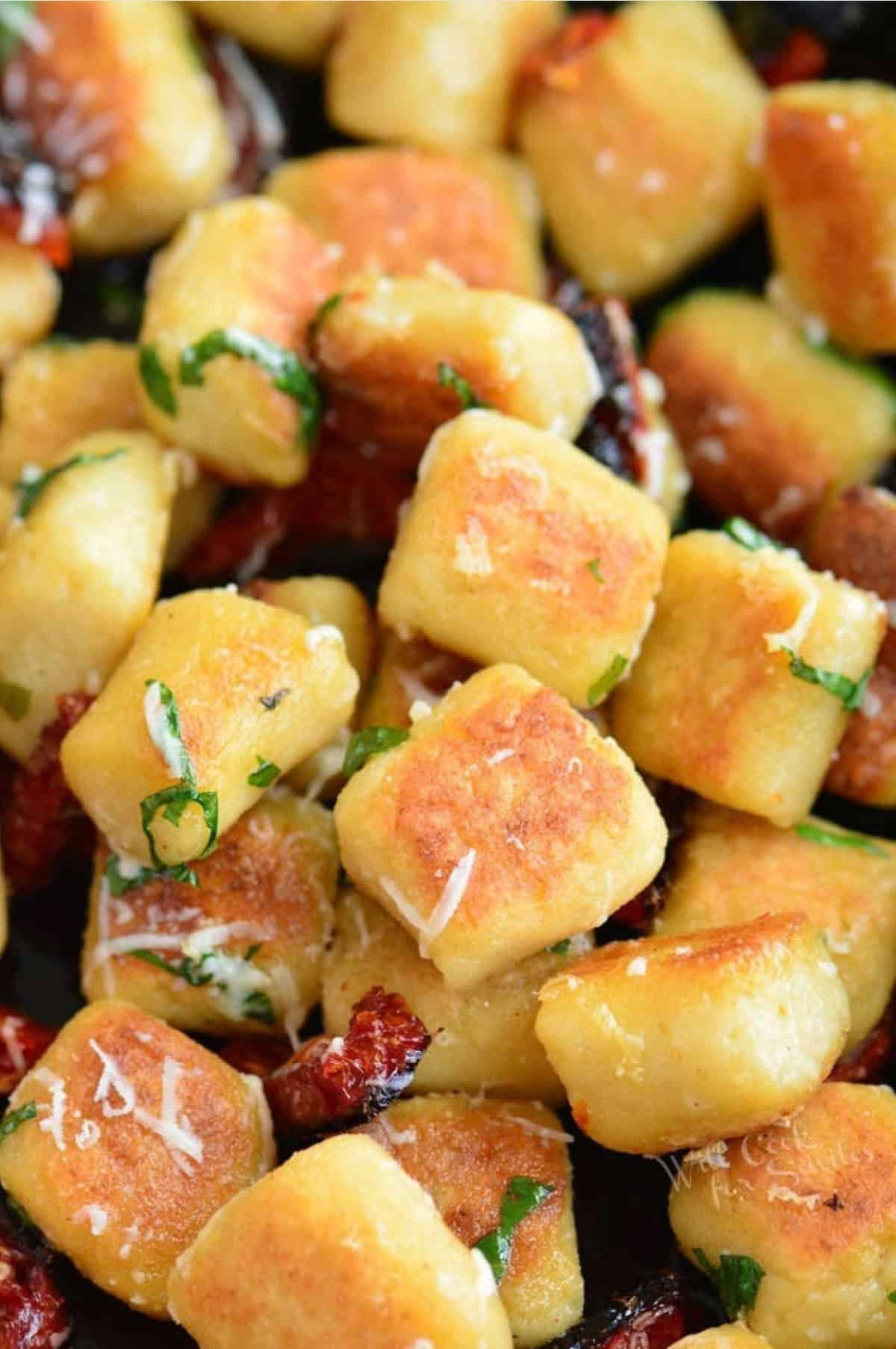 seared cauliflower gnocchi mixed with sun dried tomatoes, basil, and grated parmesan.