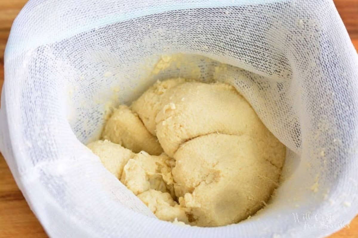 a white mesh bag filled with cooked cauliflower after squeezing it.