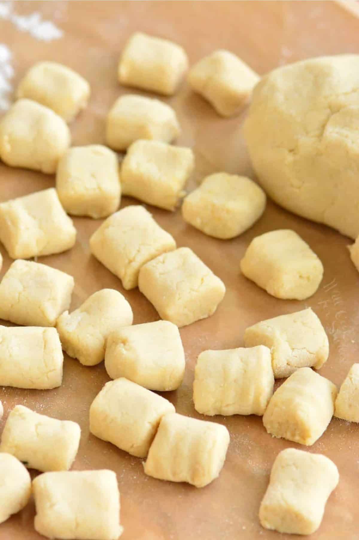 uncooked pieces of rolled and cut cauliflower gnocchi.