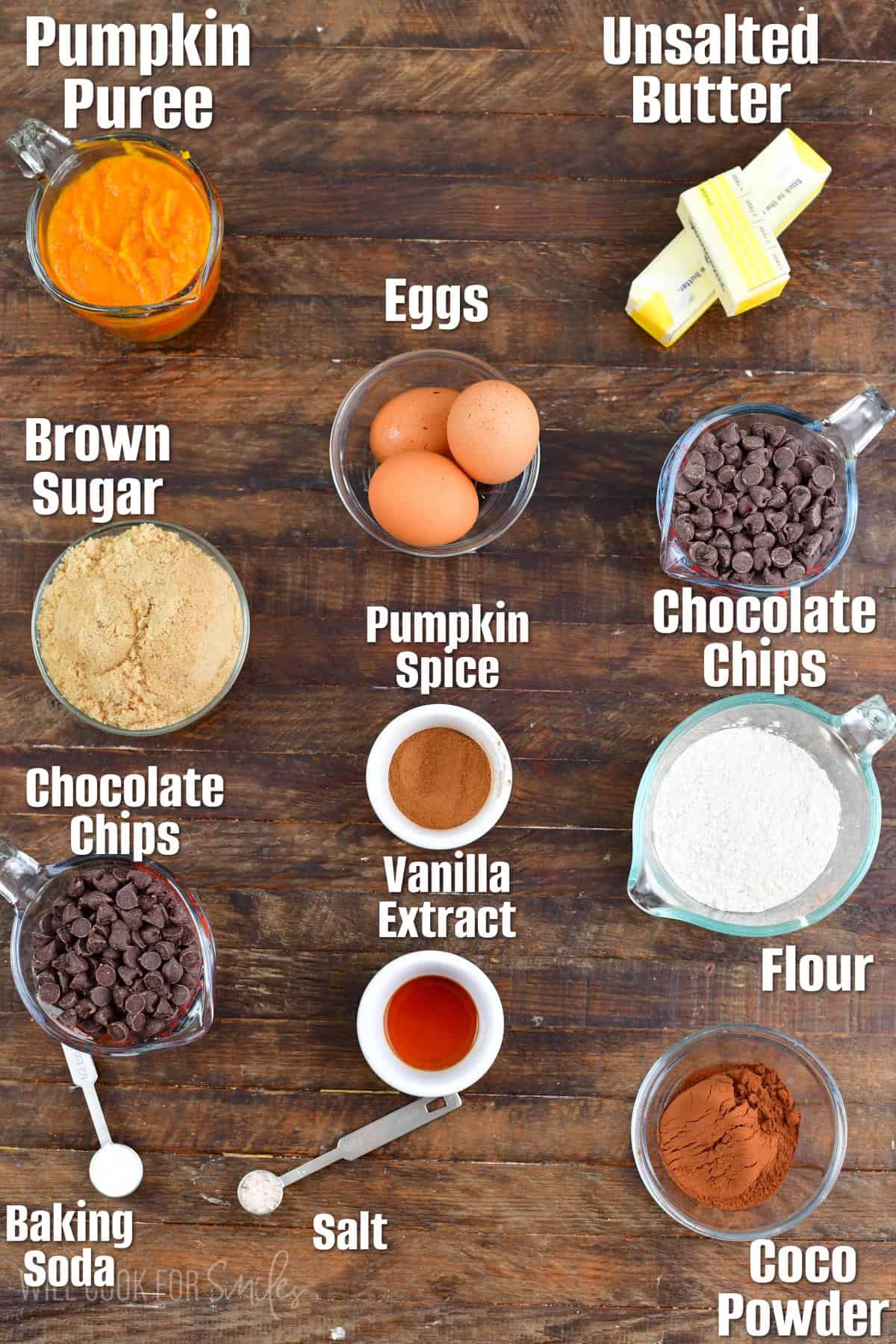 labeled ingredients to make pumpkin brownies on the wooden background. 