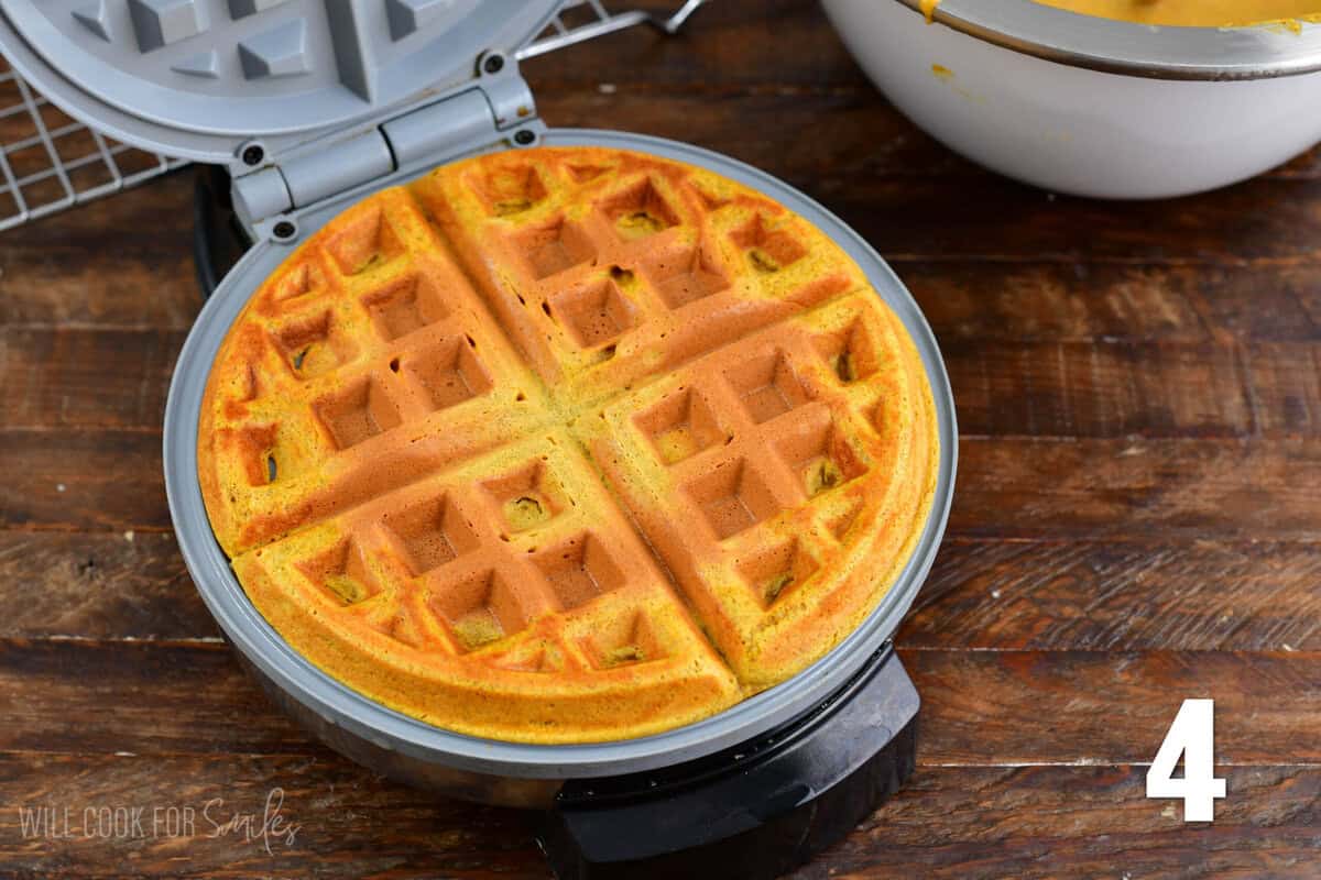 Pumpkin waffle cooked inside of the waffle maker.